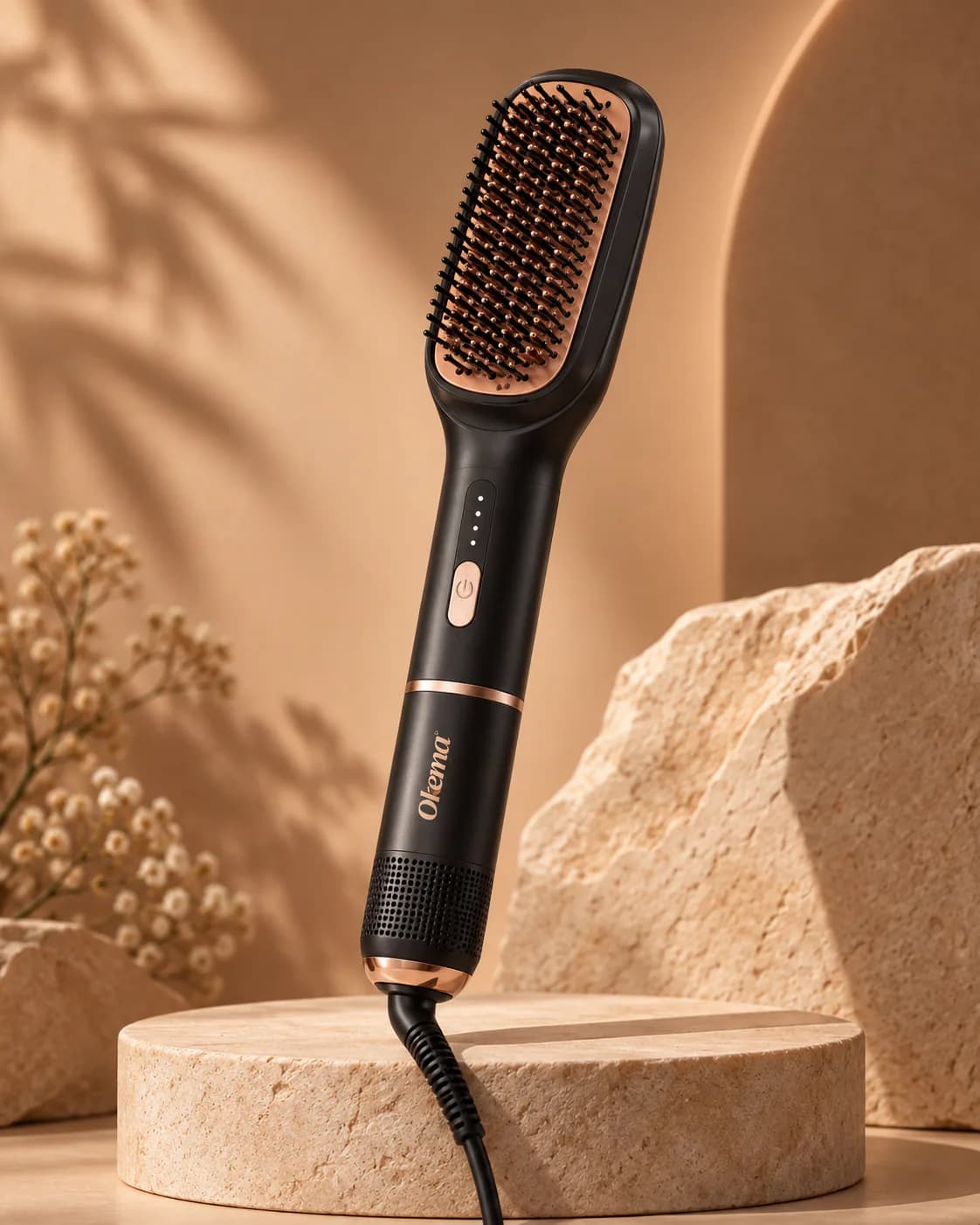 An Okema straightening brush standing upright on a travertine podium against a warm arch backdrop.